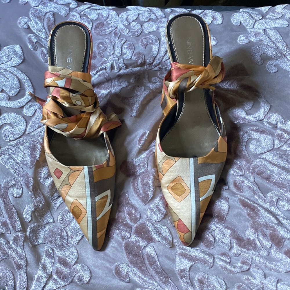 These are vintage, medium brown fabric heels. Only been worn twice.